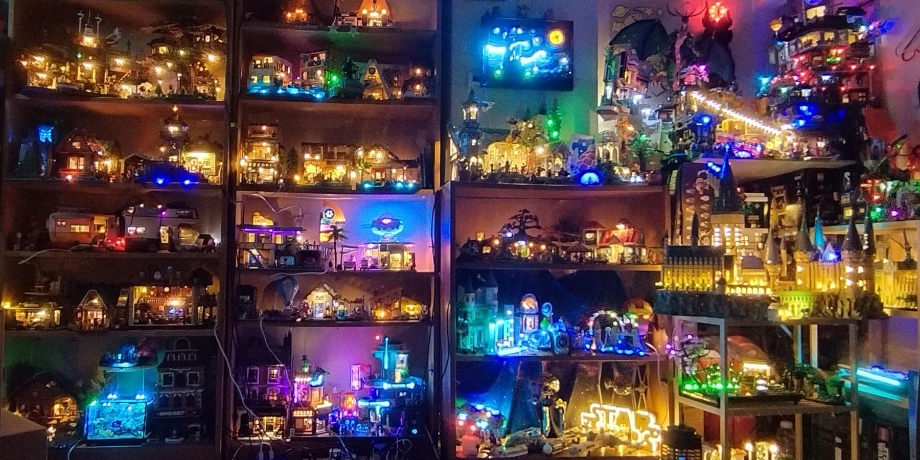 A wall of LED-lit brick builds on shelves at night, glowing in many colours